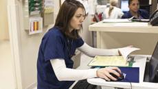 Nurse with medical form using a computer